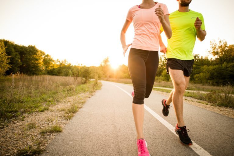 Two people jogging at sunrise