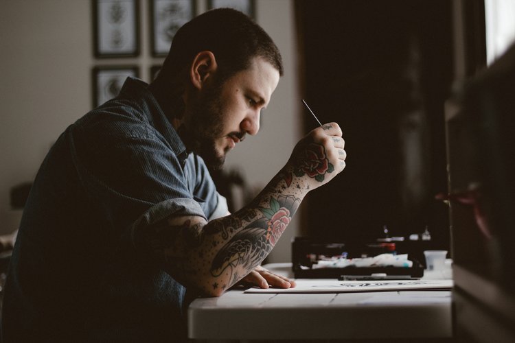 person writing at a desk