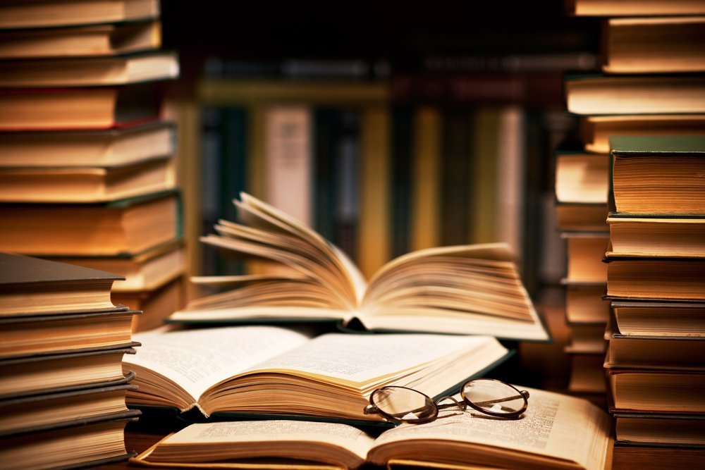 Stack of books with glasses