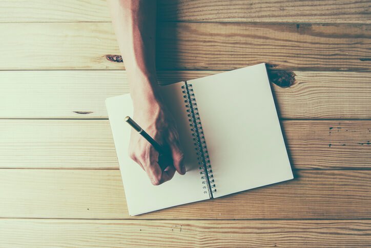 Hand writing in a journal