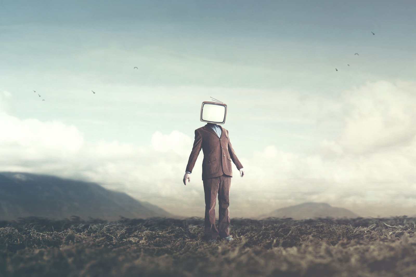 surreal picture of a man with a TV on his head