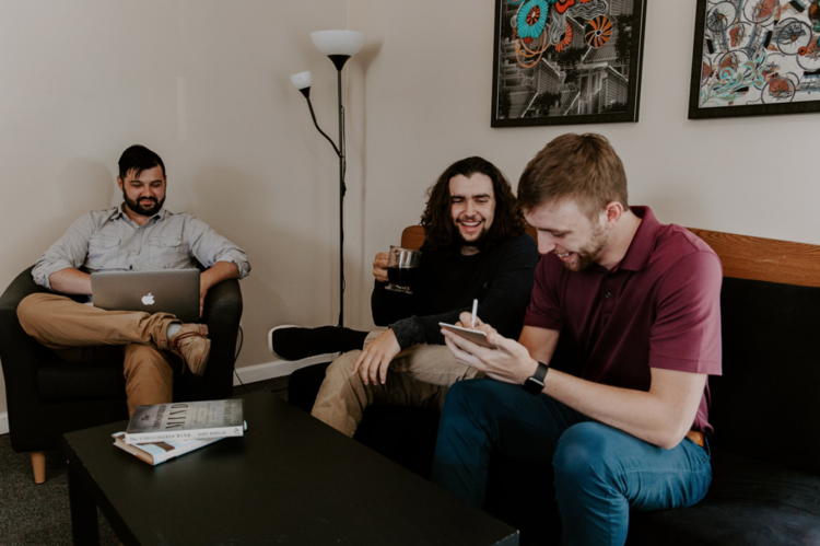 three guys talking and sitting