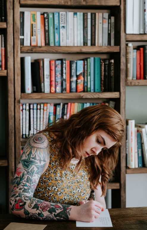 woman writing at desk
