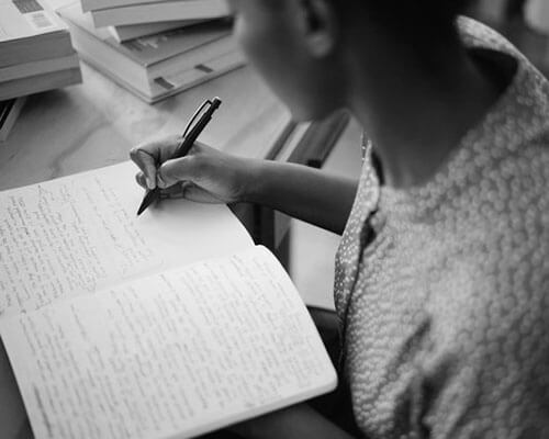 Black woman writing in a notebook