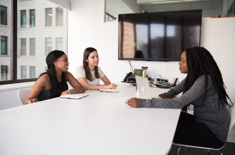 women sitting at office table