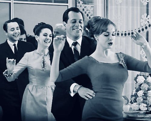 People dancing in a conga line at a party
